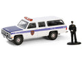 1985 GMC Suburban 2500 "New York City Transit Police Department" White with Blue Stripes and Police Officer Figure "The Hobby Shop" Series 16 1/64 Diecast Model Car by Greenlight-0